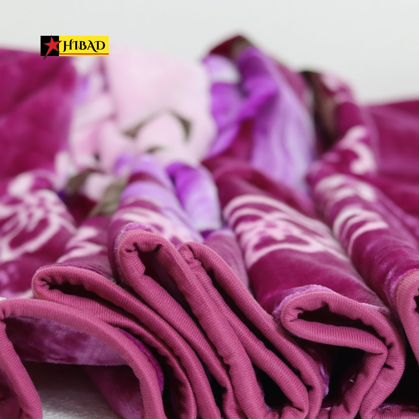 Hibad Single Blanket in shades of purple and pink, adorned with floral and abstract patterns. Made from soft Raschel fabric for a luxurious and durable experience.